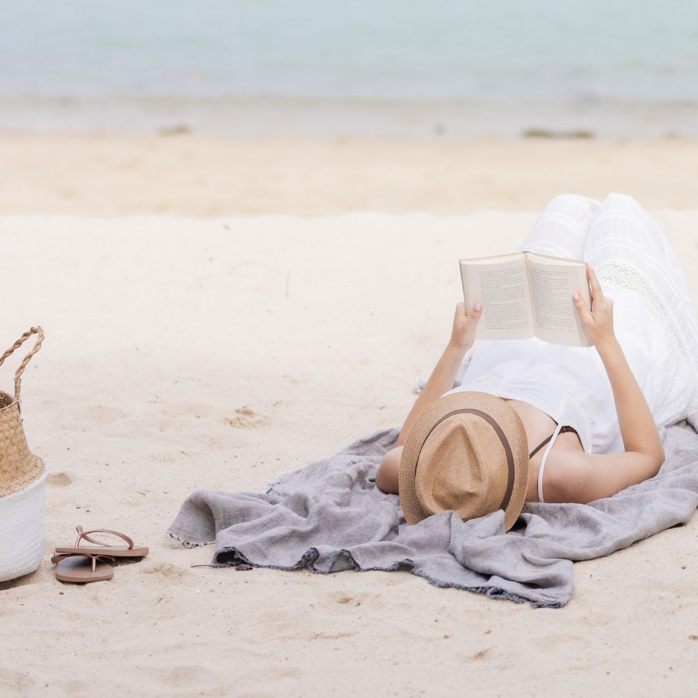 Reading on the beach to take time off.